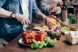 cutting board showing woman chopping veggies