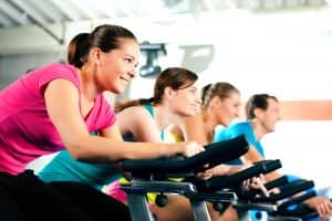 a group of people exercising on treadmills