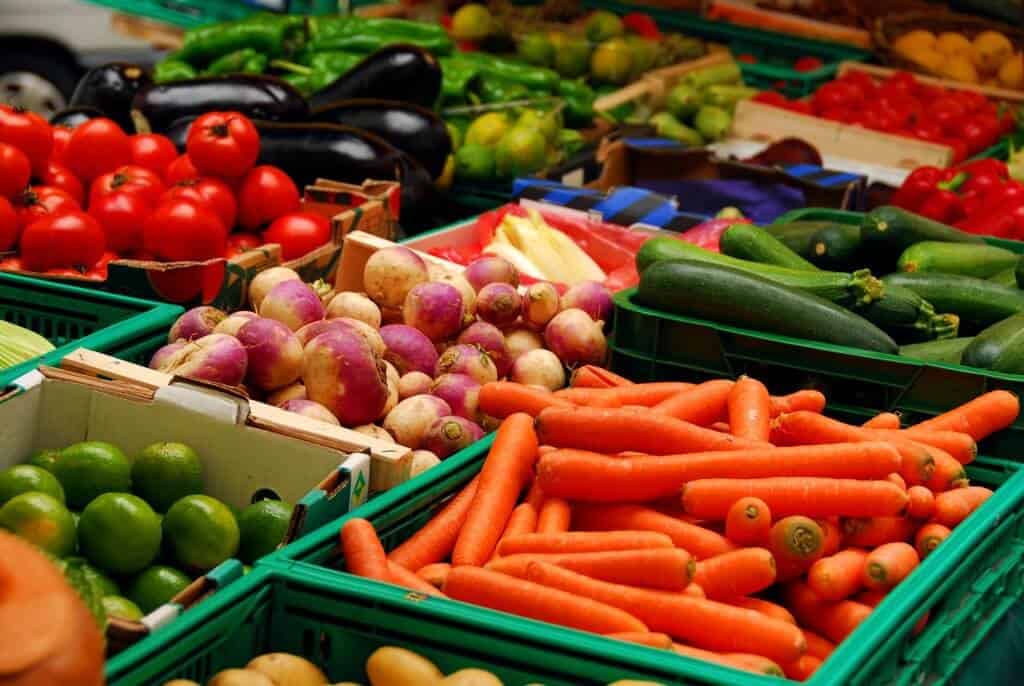 Organic Fresh assorted vegetables in boxes on farmer's market