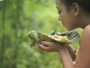 woman smelling a plate of food