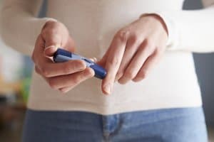 Female Diabetic Checking Blood Sugar Levels