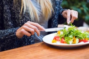 woman eating a small salad