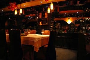 Luxury rustic styled restaurant evening interior, table for dinner