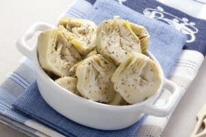 Artichoke hearts covered in herbs served as an appetizer