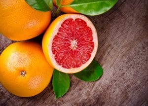 Freshly harvested grapefruit on wooden background