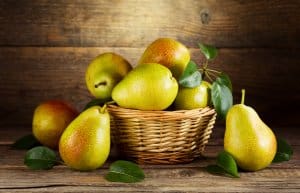 still life with fresh pears on wooden background