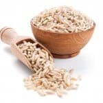 brown rice in a wooden bowl isolated on white background