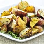 Herb roasted potatoes served on a plate