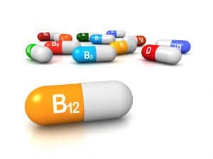 High resolution 3D render of vitamin supplements, focus on Vitamin B12 Cobalamin