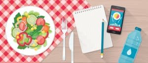 Food, diet, healthy lifestyle and weight loss banner with a dish of salad, table set, smartphone and diet plan on a notebook