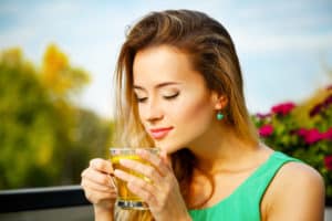 oung Woman Drinking Green Tea Outdoors